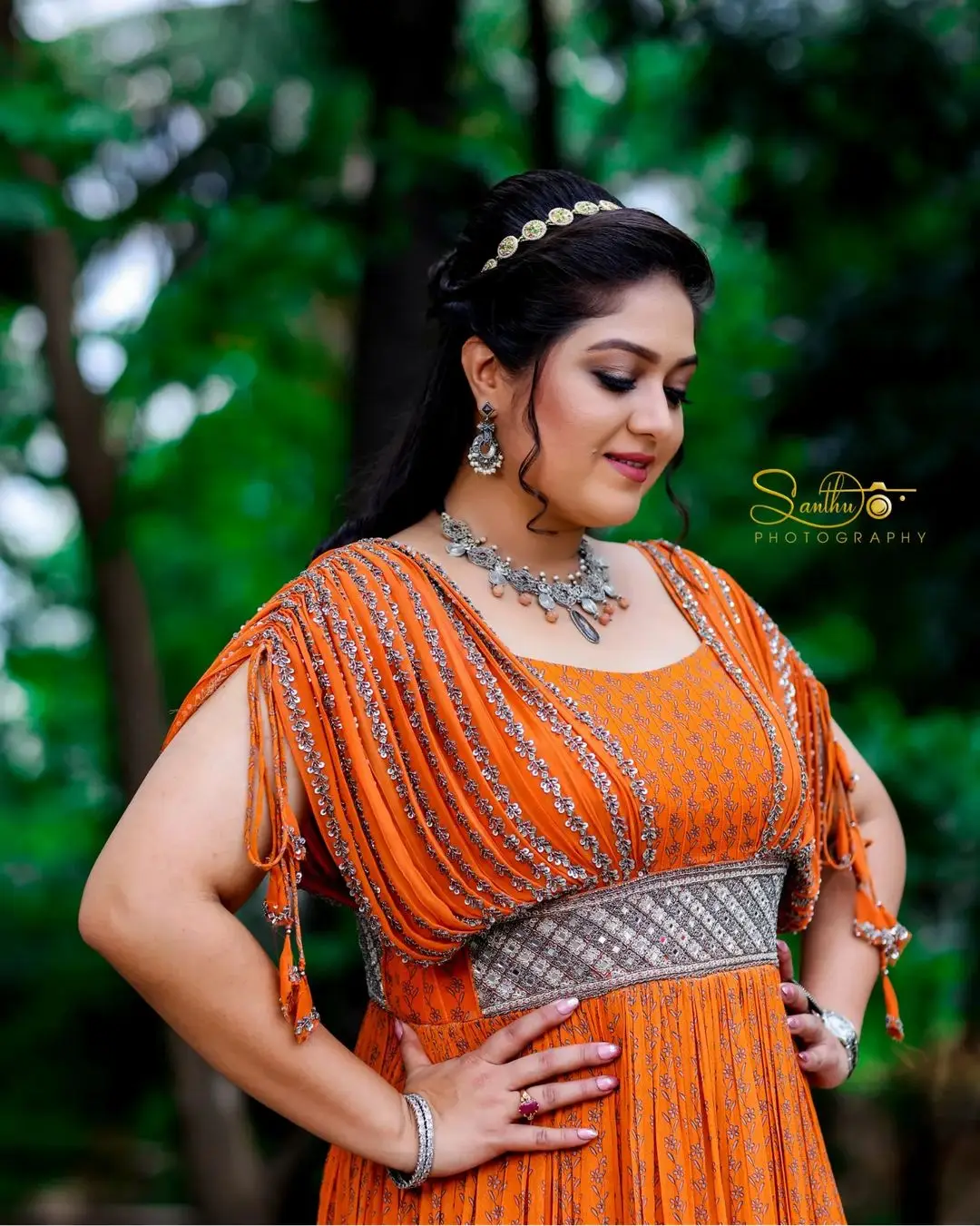 Meghana Raj Wearing Beautiful Earring Jewellery Orange Gown